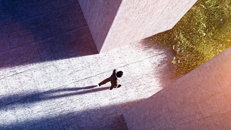 Businessman walking to open gate to a new better green world