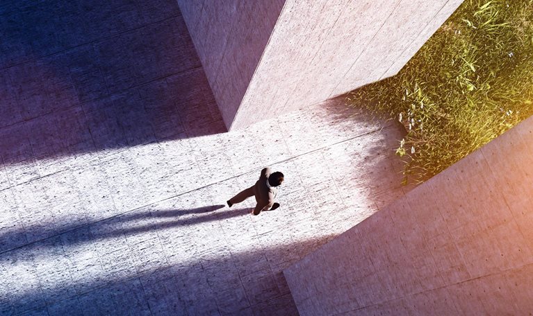 Businessman walking to open gate to a new better green world