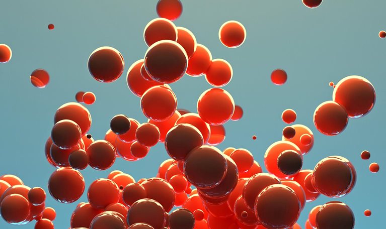 A cluster of red spheres of different sizes are released into the air