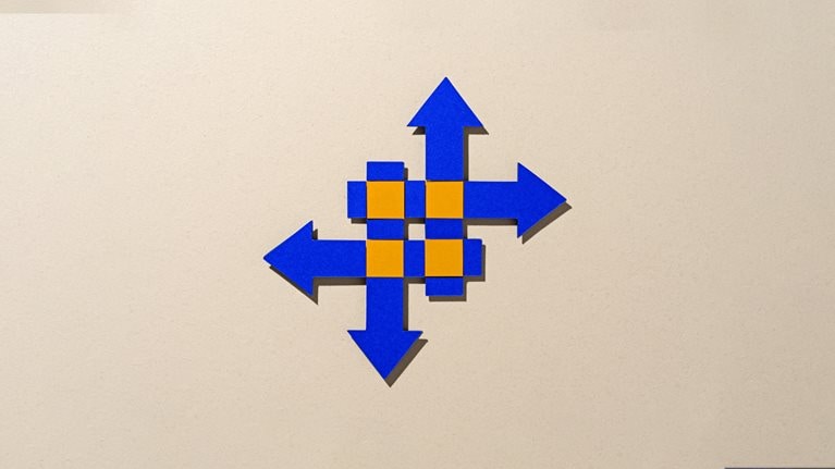 Paper-cut craft featuring four intersecting blue arrows on a beige background, with vibrant orange highlights at the crossover points, symbolizing the idea of merging and transformation