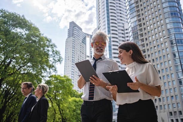 People talking outside of tall buildings