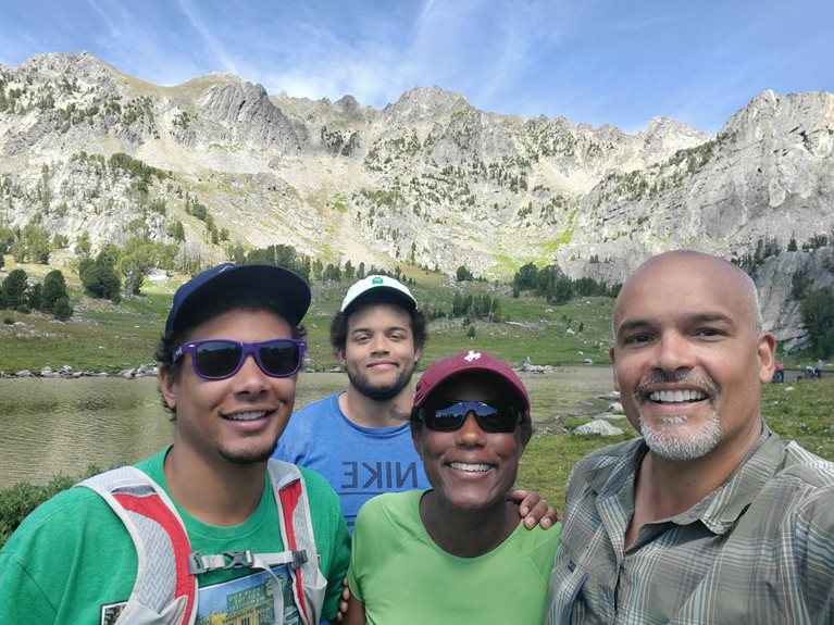 Lance with his family in the mountains
