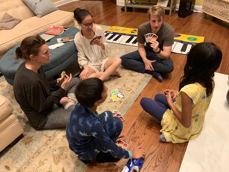 Anu hosting card game with McKinsey team at her home