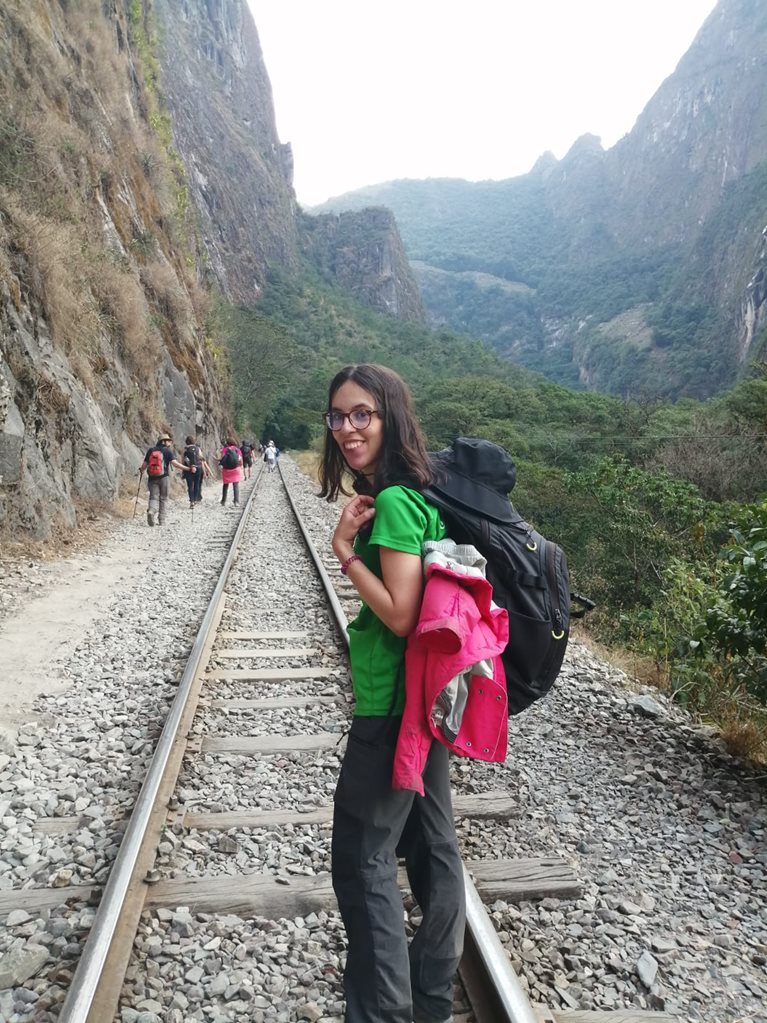 Claudia hiking along railroad track to Machu Picchu 