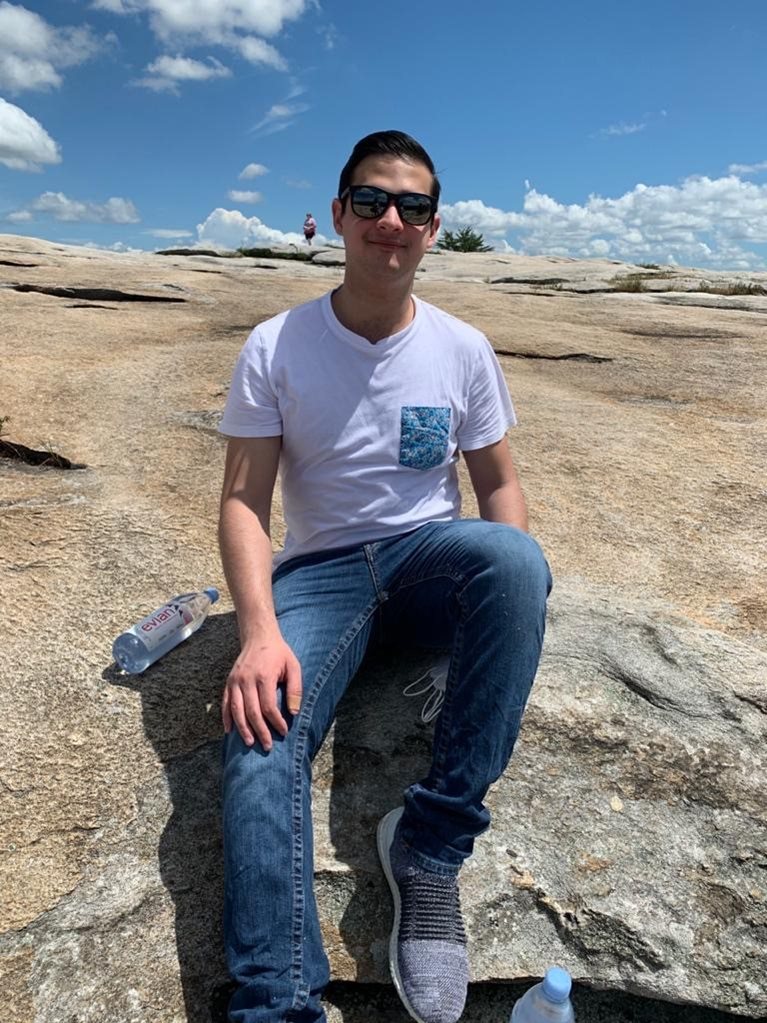Esteban sitting on a rock at Stone Mountain