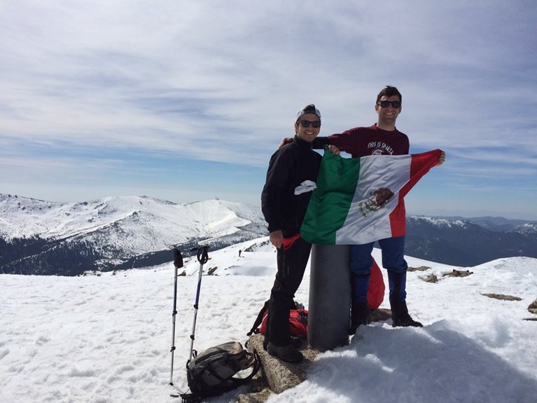 Fernando with Spanish flag on snowy mountain