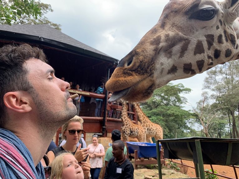 Guillermo feeding a giraffe