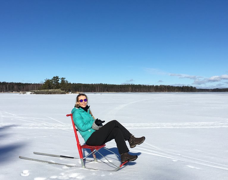 Hanna sitting on a chair on a frozen lake