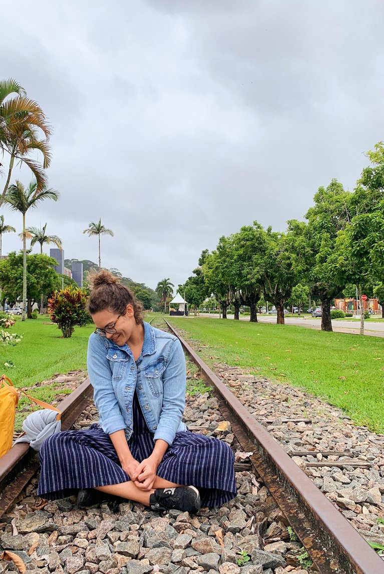 Ana sitting on abandoned railroad tracks