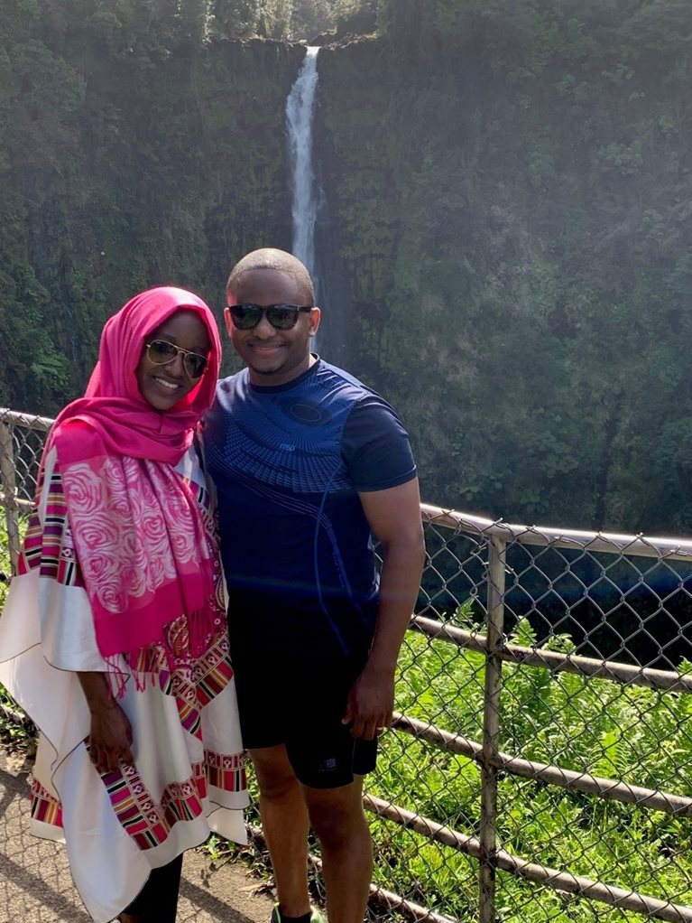 Sadiq with partner in front of Victoria Falls waterfall