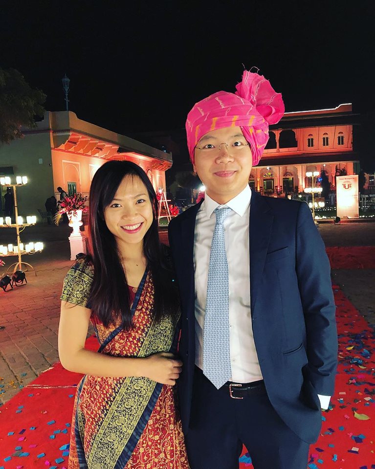 Teddy and partner in traditional clothing at a wedding