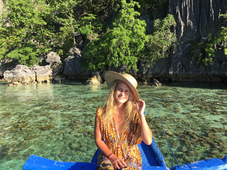 Theodora on a boat in crystal clear water