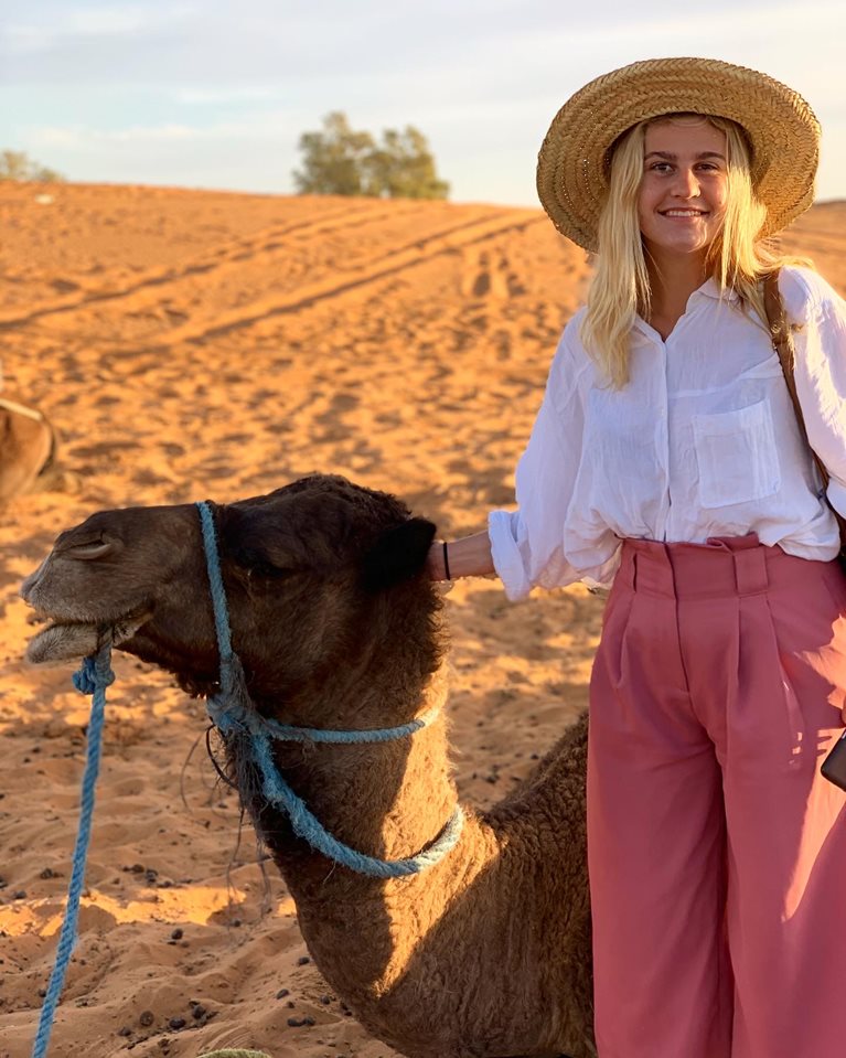 Theodora with camel in desert