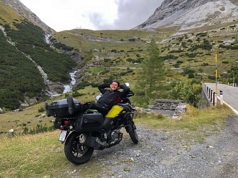 Will sitting on motorcycle in Italy