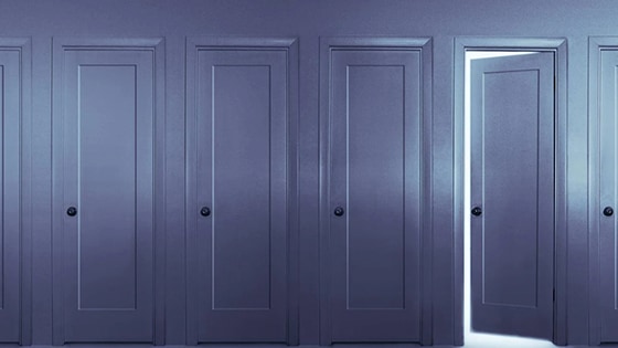 Image of three closed doors and one door slightly ajar