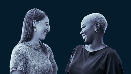 Image of two women smiling at each other