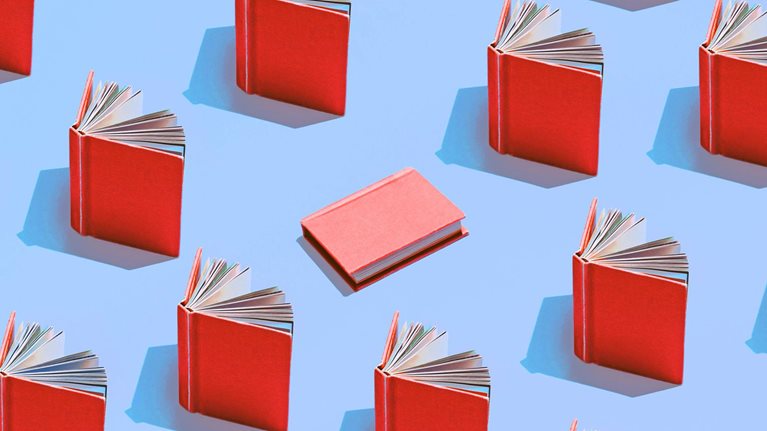 Image of multiple red books on a light blue background
