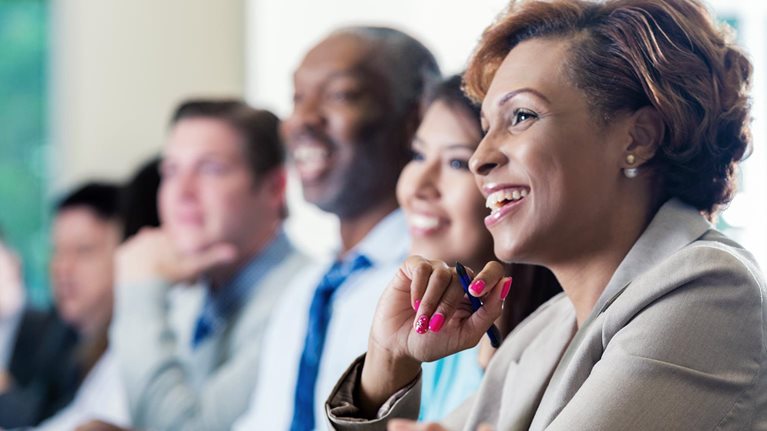 Black businesswoman attending seminar or job training business conference