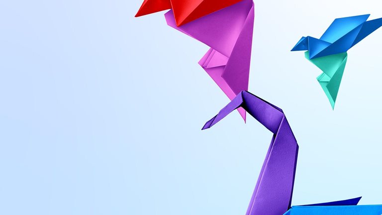Three origami birds on a light blue background