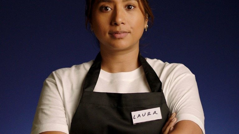 Frontline worker of color in an apron.