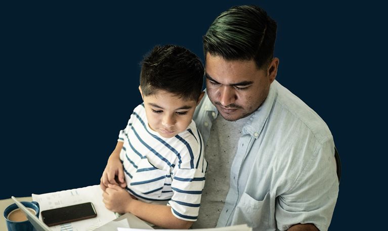 Father working with his son using laptop at home