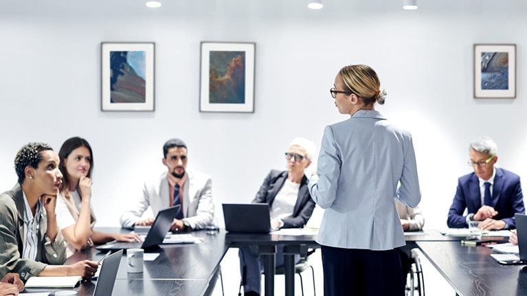 Businesswoman sharing ideas with colleagues