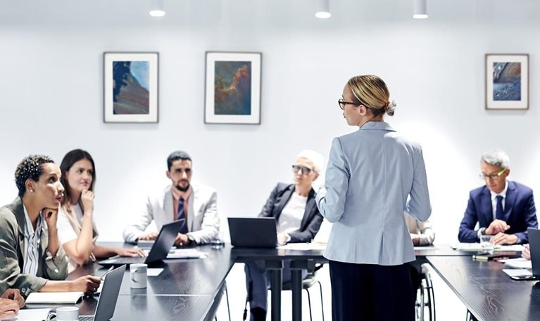 Businesswoman sharing ideas with colleagues