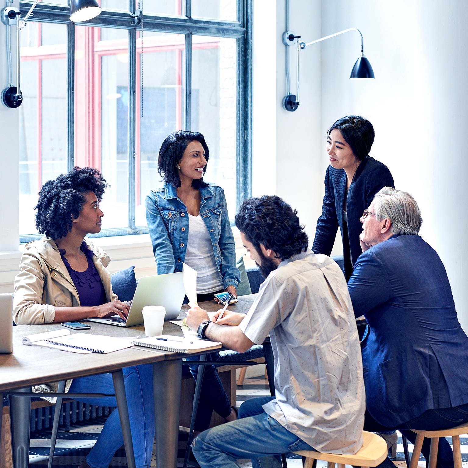 Diverse group of business people having discussion during meeting in office