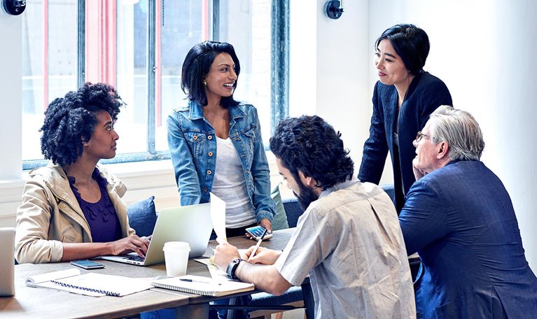 Diverse group of business people having discussion during meeting in office