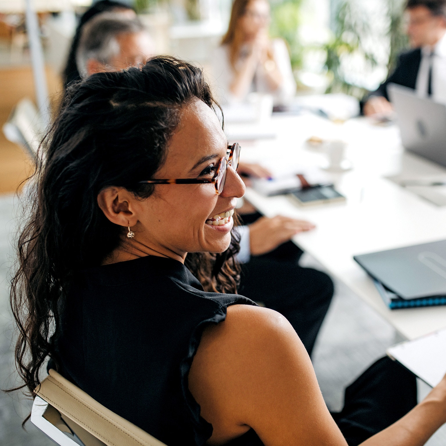  Closeup of Hispanic businesswoman in office meeting