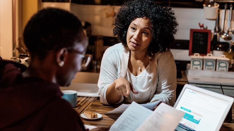 Mother and daughter dealing with home finances