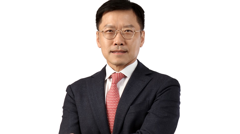 Photograph of Lee Yuan Siong in a dark suit and red tie against a white background