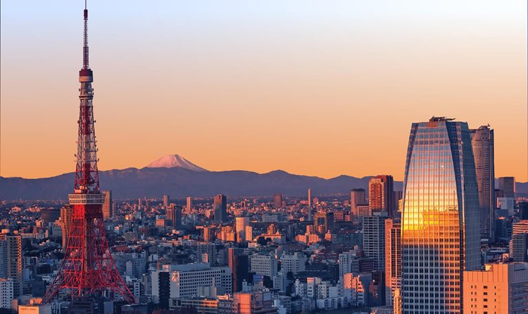 Tokyo Skyline at sunrise with Tokyo Tower and snowy Mount Fuji.