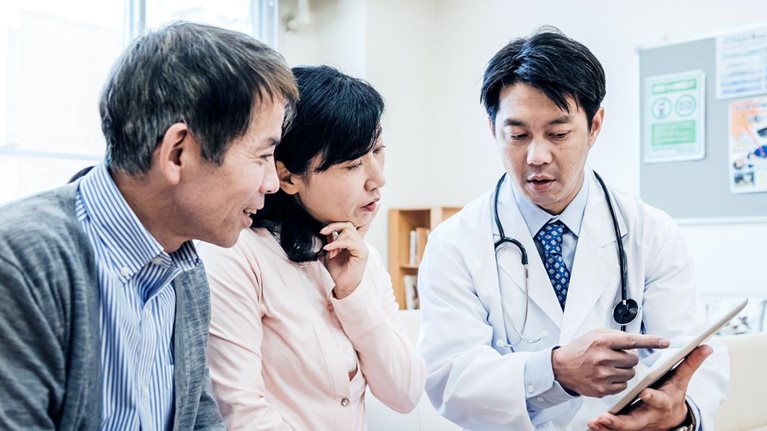 Two adults consulting a doctor
