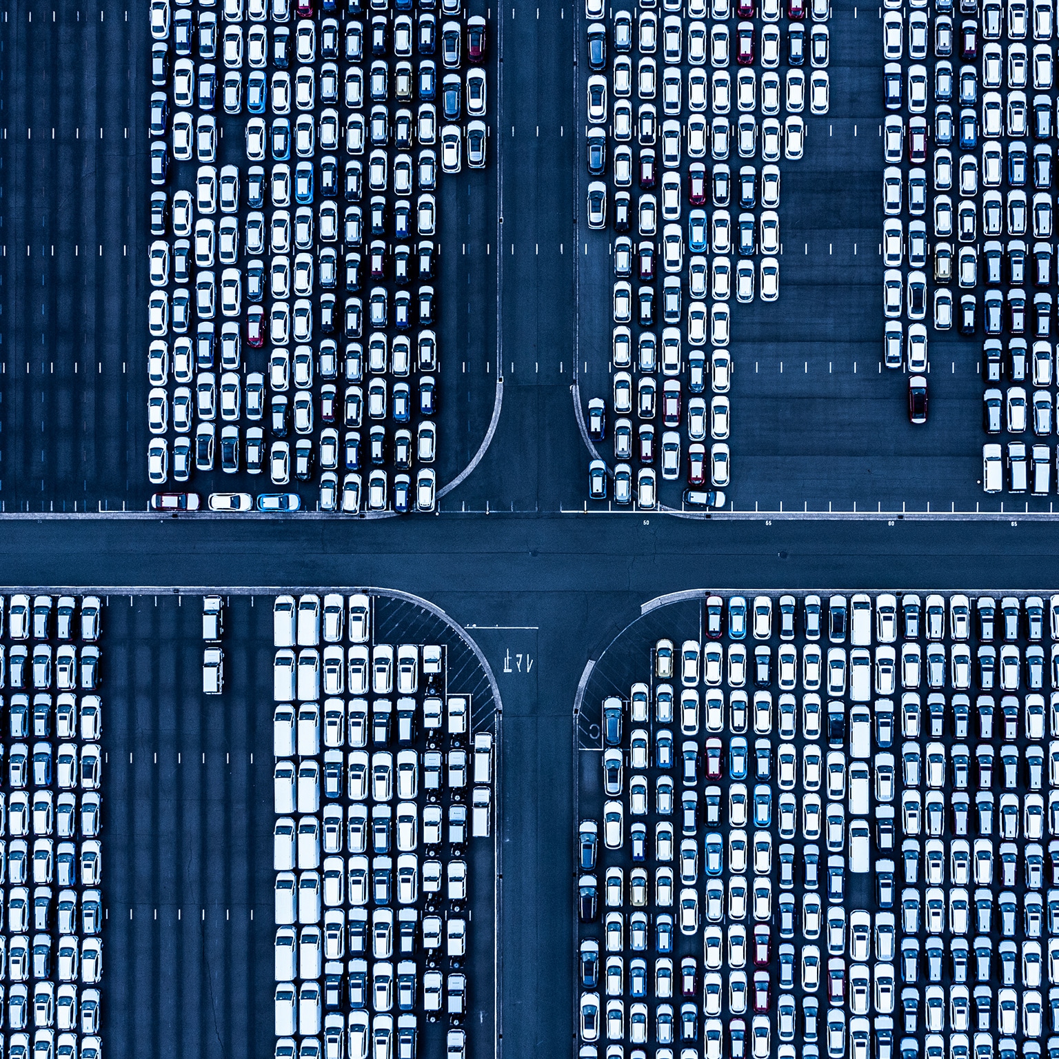 overhead view of cars in airport parking lot - stock photo