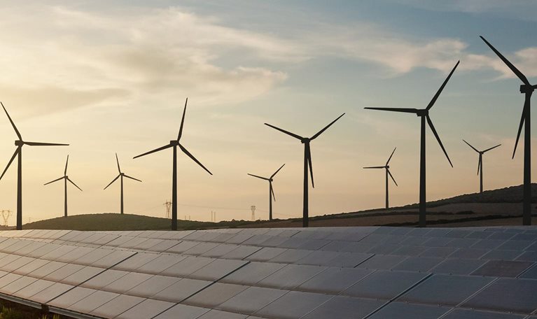 Solar and wind energy farm - stock photo
