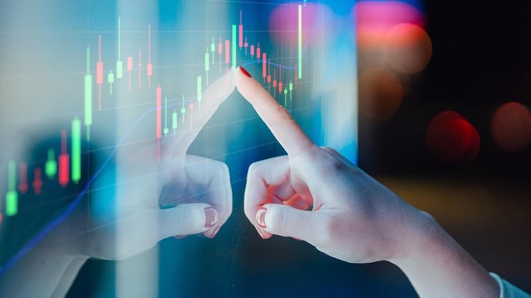 Businesswomen touching stock market graph on a virtual screen display - stock photo