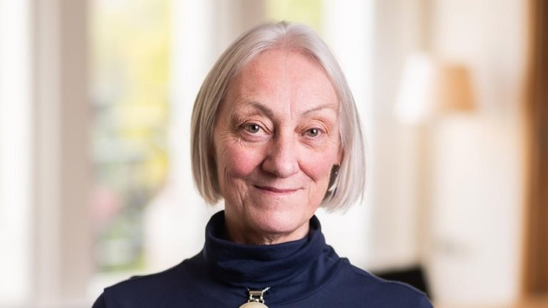 Portrait of Lucy Parker in a brightly lit dinning room.