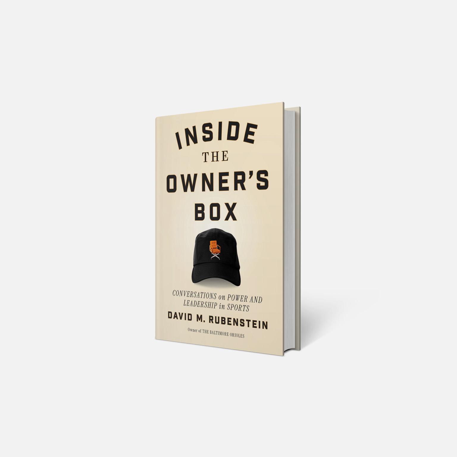 3D rendering of a beige book on a light gray background with the cover text “Inside the Owner’s Box,” “Conversations on Power and Leadership in Sports,” and “David M. Rubenstein.” The cover includes an image of a black baseball cap with a small orange chair graphic.