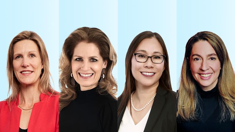A polyptych with professional head-and-shoulders portraits of Lucy Pérez, Kana Enomoto, Jacqueline Brassey, and Erica Coe arranged side by side against a light blue background. Each woman is facing the camera and smiling, wearing business or business-casual attire, giving the overall impression of a polished, corporate-style team photo.