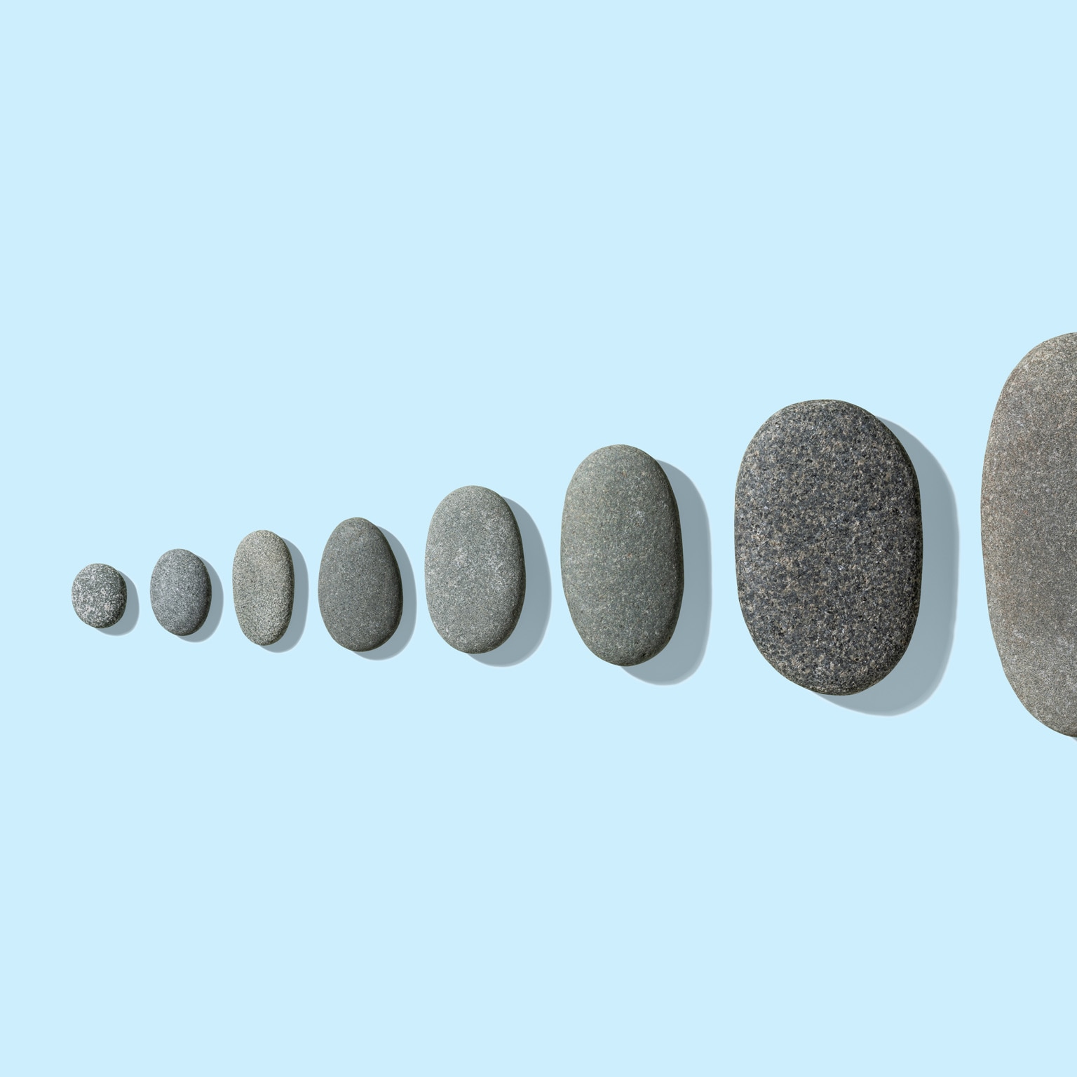 Gray pebbles neatly arranged from small to large