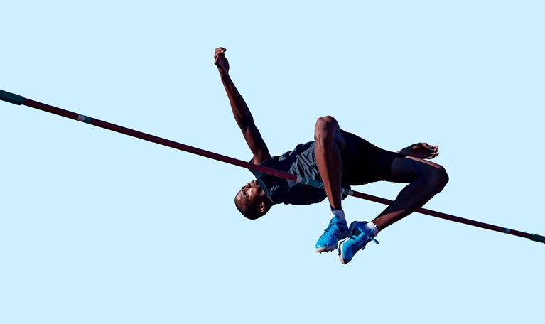 Male athlete doing high jump