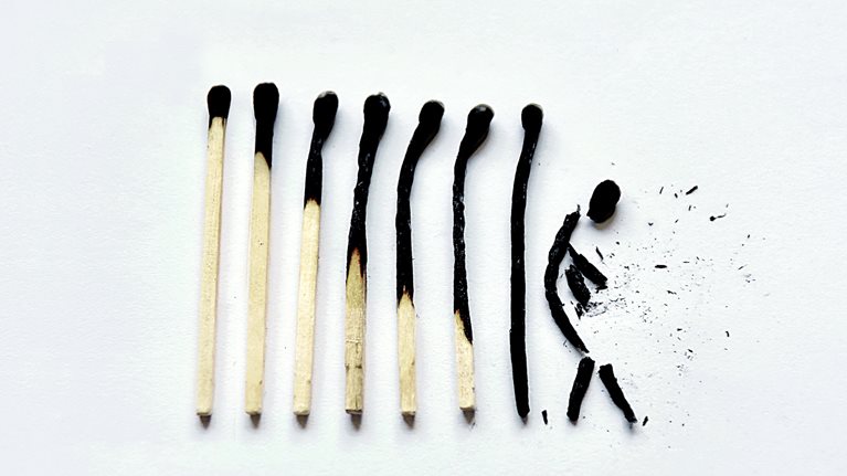 A row of 8 matches that go from lightly to completely burnt. The last match is broken into a shape that resembles a human figure. 
