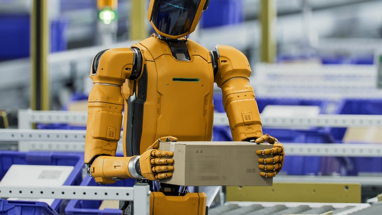 A robot holding a package, working in an assembly line