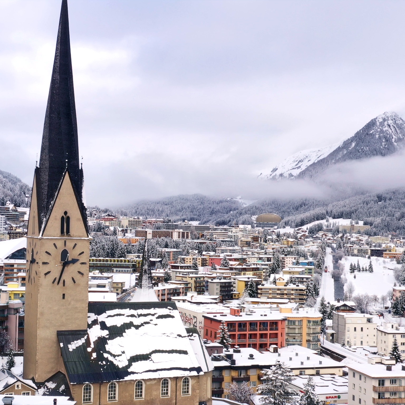 Photo of buildings with mountains in the background