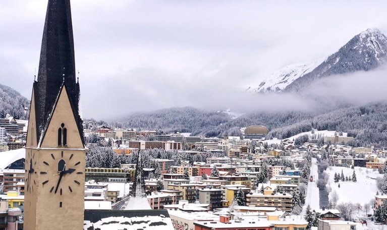 Photo of buildings with mountains in the background