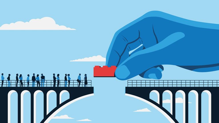 An illustration dominated by bold blue hues, with a prominent hand adding a single red Lego brick to complete a section of a bridge. Figures in silhouette can be seen on one end of the unfinished bridge, eagerly anticipating its finalization.