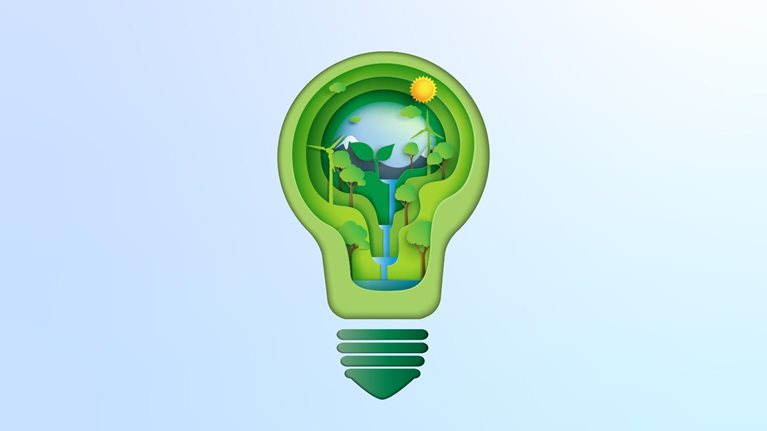 Paper cutout of light bulb with natural environment, waterfall, sunflower, and wind turbine inside it.