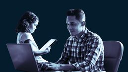 Father and daughter working together at desk