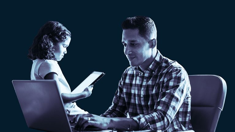 Father and daughter working together at desk